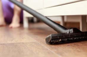 Vacuuming-under-furniture-getting-rid-of-dust-bunnies